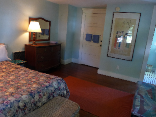 blue room has a queen bed and a futon, private bath room in side