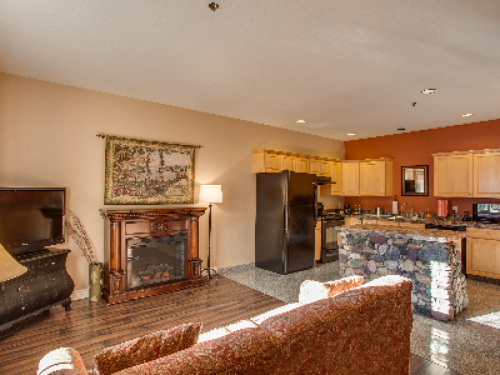 Rustic Chic Suite features Full Kitchen, Dining Area, Bedroom and Living Room with Electric Fireplace and 2 flatscreen televisions.