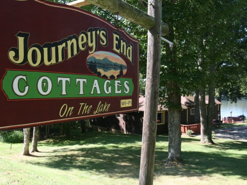 Journey's End Sign by Road Looking toward lake
