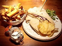 Ham hock and mature cheddar cheese sandwich with homemade chips.