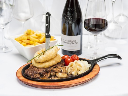 Our restaurant menu : Local Striploin Steak cooked to your liking served on a hot sizzle pan