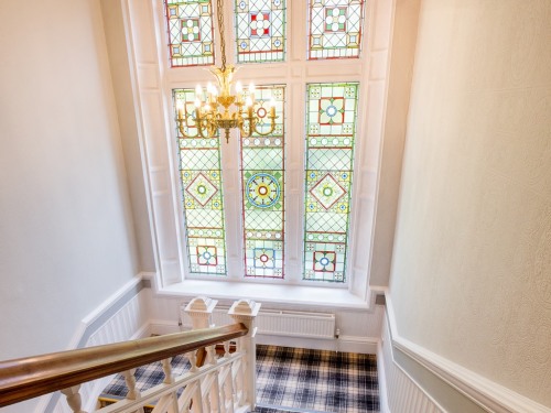 The stained glass window on the main staircase restored to former Victorian splendour