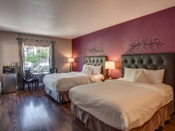 Deluxe Room with Two Queen Pillowtop Beds dressed in Luxurious Linens and Down Comforter, Flatscreen Television, Microwave, Mini Refrigerator and Coffeemaker.